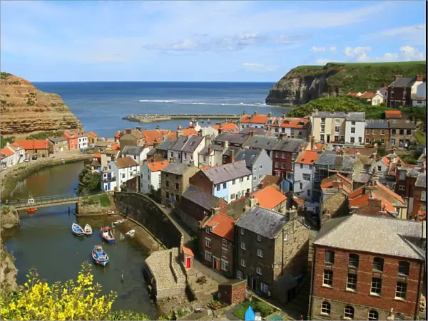 Looking seawards over cottage rooftops of the fishing village of Staithes, North Yorkshire, England