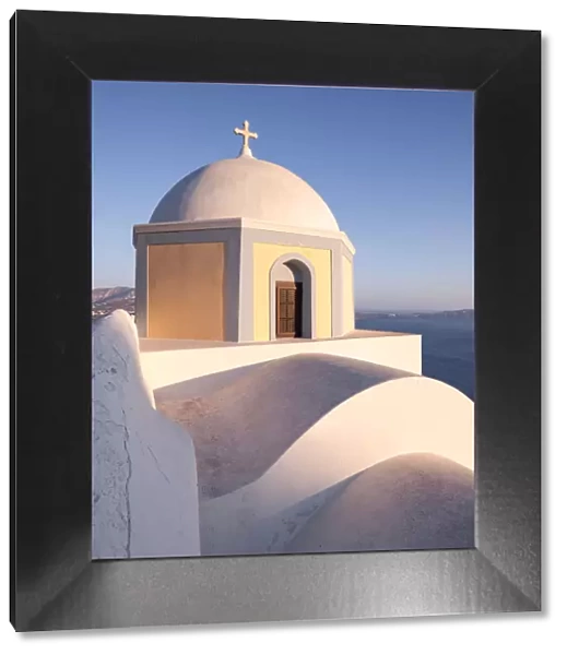 Famous orthodox church at sunset Santorini, Greece