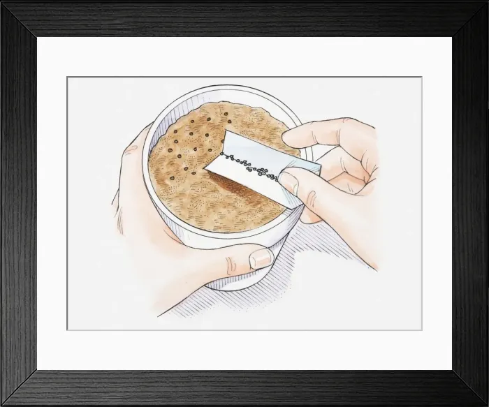 Framed Print : Illustration of hand scattering seeds on compost in plant pot, using a piece of folded paper, close-up