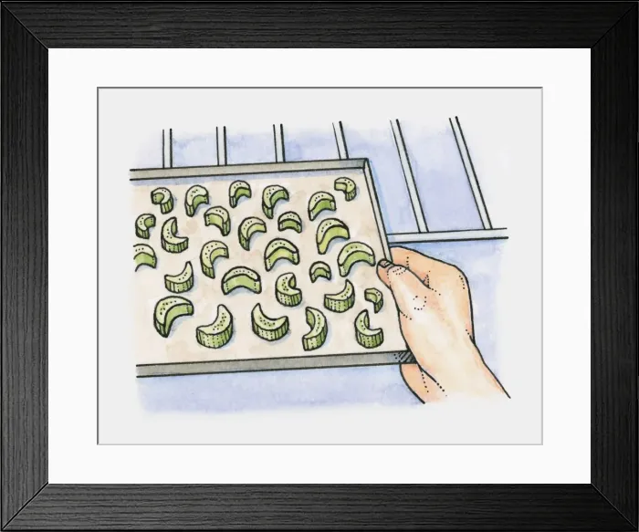 Framed Print : Pieces of celery on a baking tray being placed in the oven Framed Print : Pieces of celery on a baking tray being placed in the oven