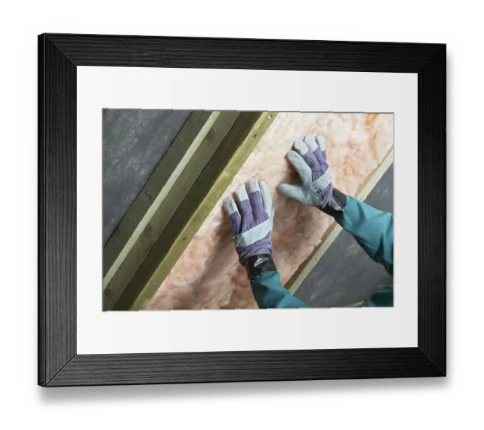 Framed Print : Man installing roof insulation in rafter, close-up Framed Print : Man installing roof insulation in rafter, close-up