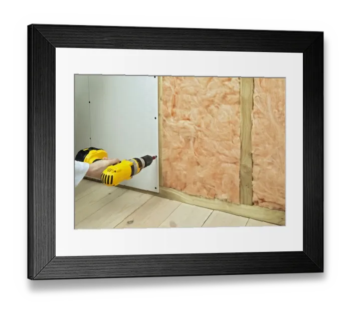 Framed Print : Man drilling screws in plasterboard and batten to hide insulation, close-up Framed Print : Man drilling screws in plasterboard and batten to hide insulation, close-up