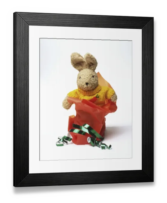 Framed Print : Toy rabbit with wrapping paper and ribbons