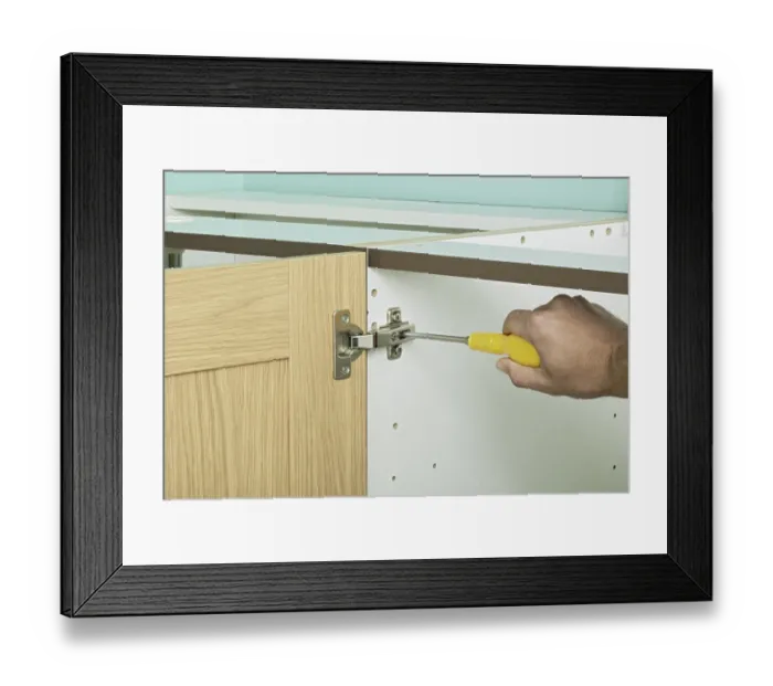 Framed Print : Tightening central screw in a hinge with a screw driver, close up Framed Print : Tightening central screw in a hinge with a screw driver, close up