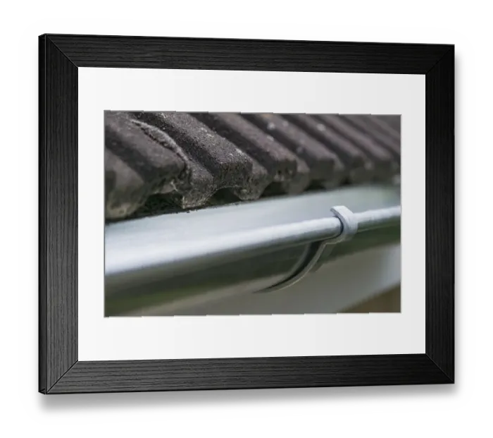 Framed Print : Guttering on the side of a house roof Framed Print : Guttering on the side of a house roof