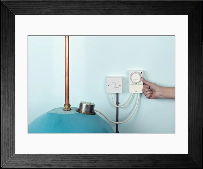 Framed Print : Hand against side of heater timer Framed Print : Hand against side of heater timer