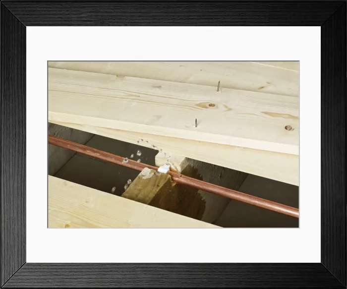 Framed Print : Pipe with hole in exposed under floor boards Framed Print : Pipe with hole in exposed under floor boards