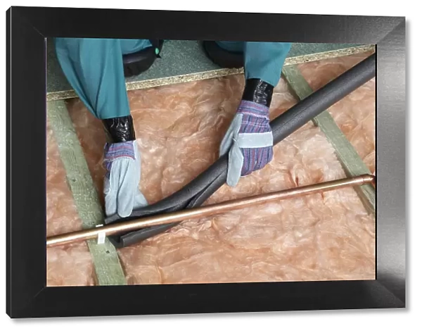 Attaching pipe insulation to a copper pipe above joists and insulation blanket