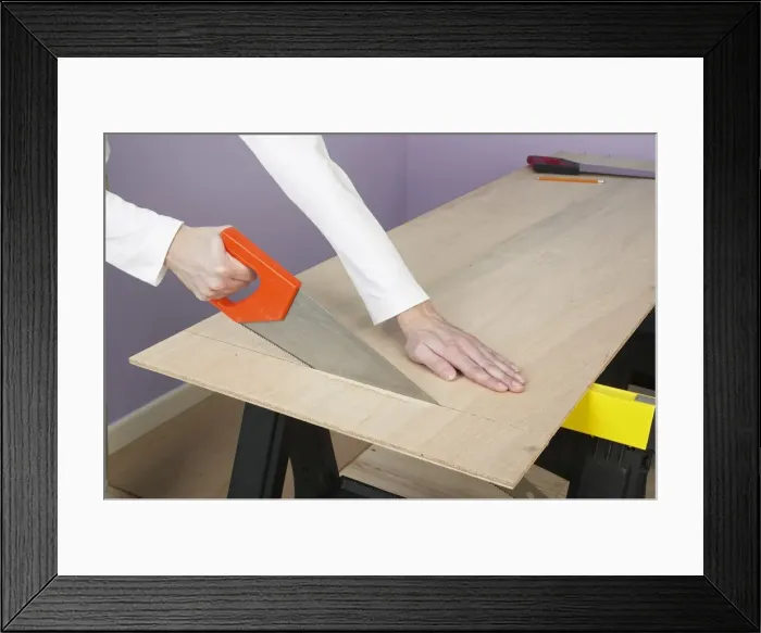 Framed Print : Sawing through plywood