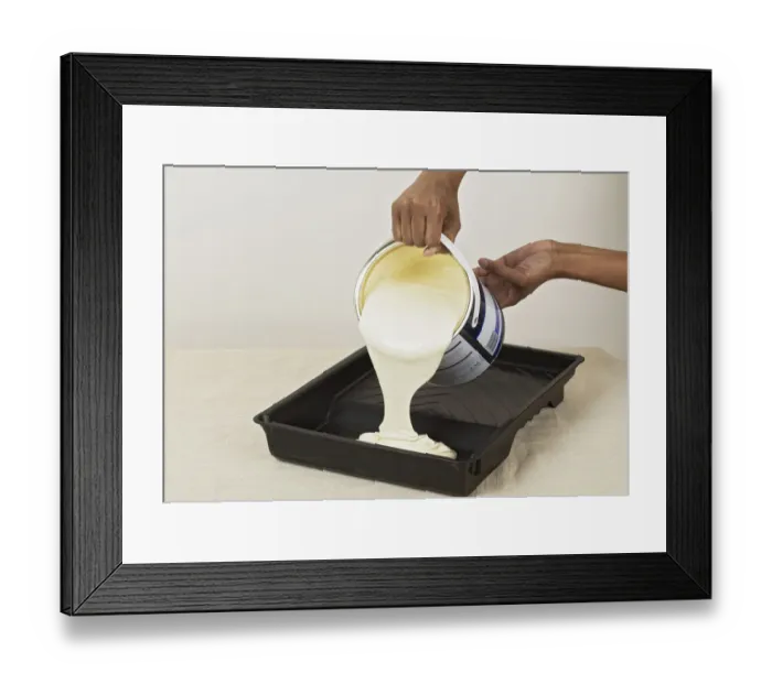 Framed Print : Pouring yellow paint in to a roller tray Framed Print : Pouring yellow paint in to a roller tray