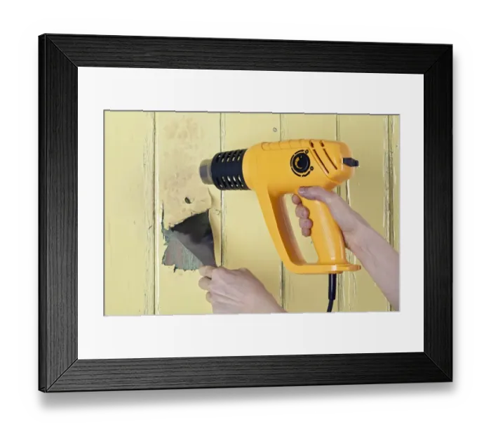 Framed Print : Using a heat gun and scraper to strip paint from a wooden surface Framed Print : Using a heat gun and scraper to strip paint from a wooden surface