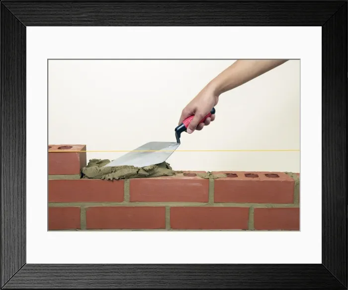 Framed Print : Evening off mortar on bricks with a trowel Framed Print : Evening off mortar on bricks with a trowel