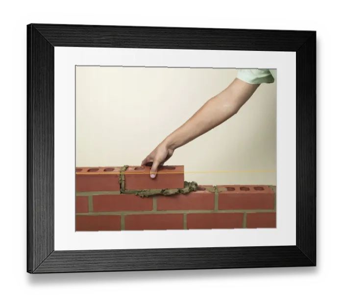 Framed Print : Placing a new brick on to fresh mortar on a wall Framed Print : Placing a new brick on to fresh mortar on a wall
