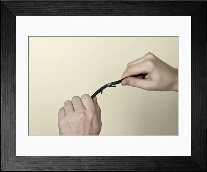 Framed Print : Pair of hands holding exposed wire Framed Print : Pair of hands holding exposed wire