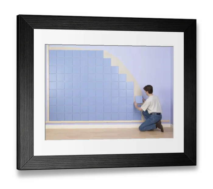 Framed Print : Man placing tile on wall Framed Print : Man placing tile on wall