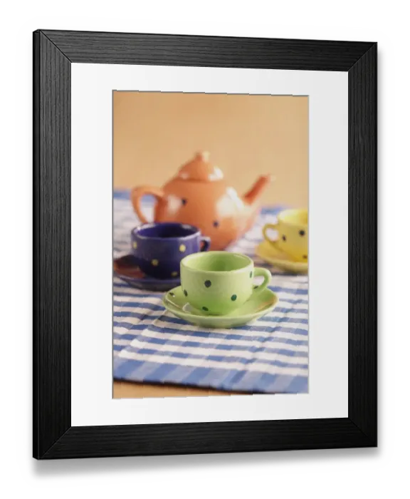 Framed Print : Teapot, cups and saucers on a chequered table cloth Framed Print : Teapot, cups and saucers on a chequered table cloth
