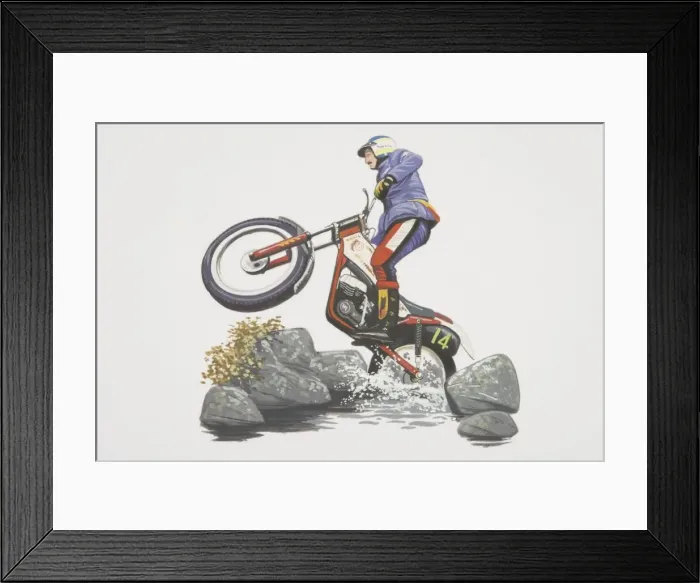 Framed Print : Motorcycle rider performing a wheelie while negociating rocks and water, low angle side view Framed Print : Motorcycle rider performing a wheelie while negociating rocks and water, low angle side view