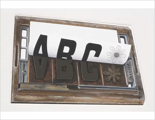 Sheet of paper peeling away from a printing forme imprinted with the letters ABC and image of a flower