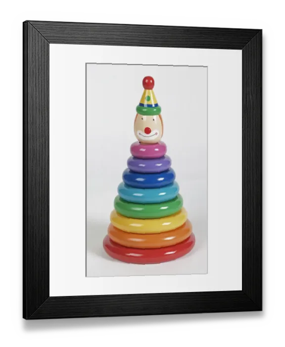 Framed Print : Colourful plastic rings stacked on pole with smiling clown head at the top, close up Framed Print : Colourful plastic rings stacked on pole with smiling clown head at the top, close up