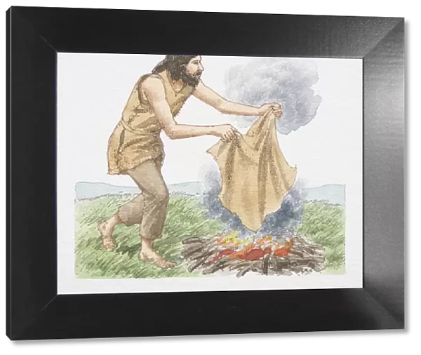 Man holding blanket over open fire to create smoke signals, side view