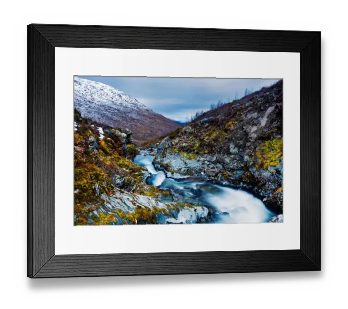 Framed Print : Snow thaw. Stream winds itself down mountain pass at top of snow road in Norway Framed Print : Snow thaw. Stream winds itself down mountain pass at top of snow road in Norway