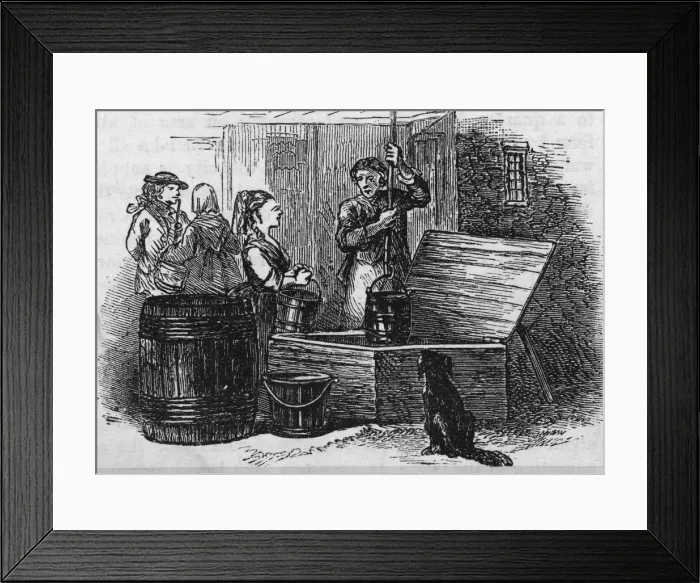 Framed Print : Draw Well. A man operates a draw well while a women waits for a turn Framed Print : Draw Well. A man operates a draw well while a women waits for a turn