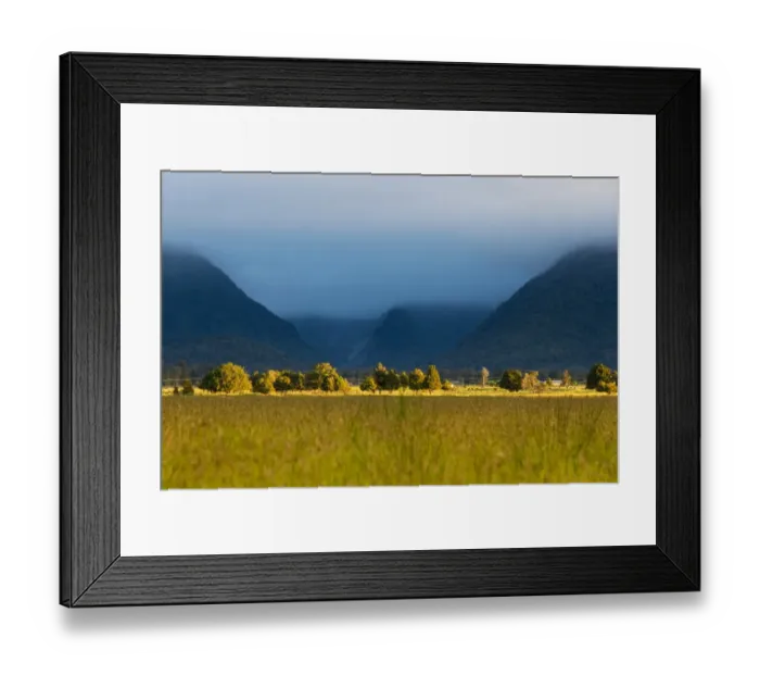 Framed Print : Landscape of green meadow and mountain range Framed Print : Landscape of green meadow and mountain range