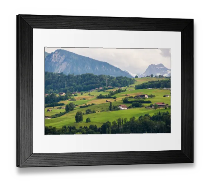 Framed Print : Small village over the meadow near lake Thun Framed Print : Small village over the meadow near lake Thun
