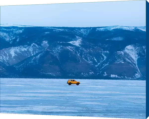 A yellow car on the frozen Baikal lake