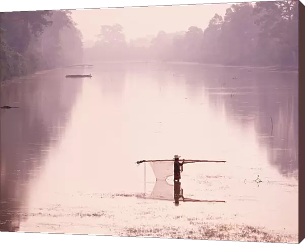 Woman carrying fishing net across river