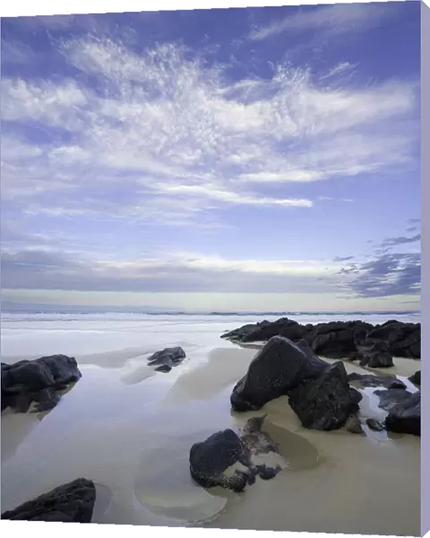 Eroded black rocks on beach, Australia