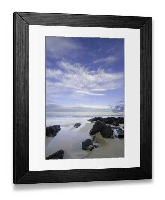 Framed Print : Eroded black rocks on beach, Australia