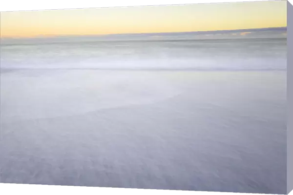 Waves breaking on beach, dawn, (long exposure)