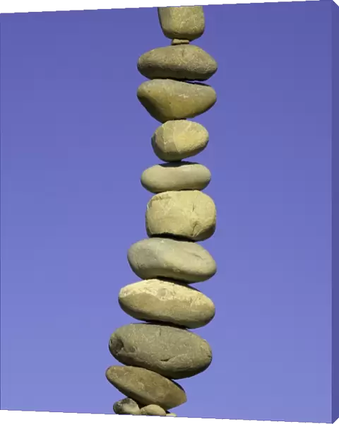 Stack of stones on fence post, low angle view