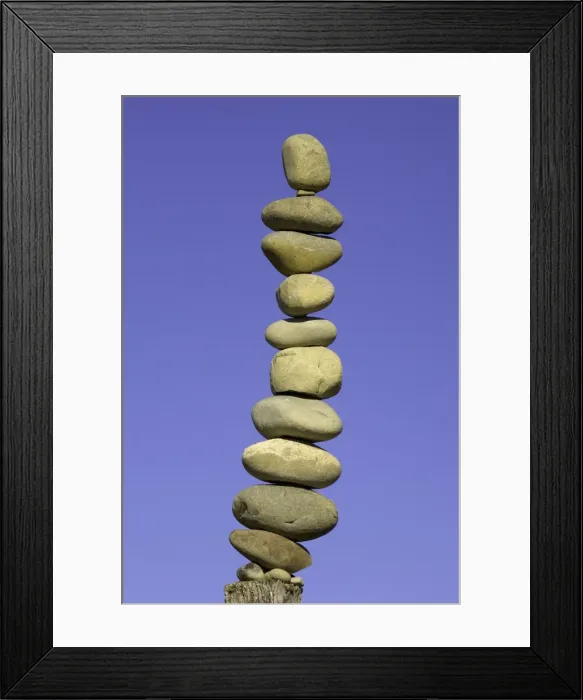 Framed Print : Stack of stones on fence post, low angle view Framed Print : Stack of stones on fence post, low angle view