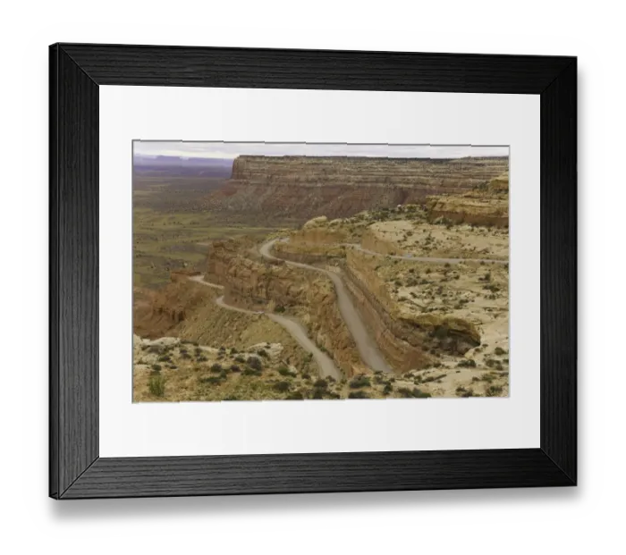 Framed Print : USA, Utah, cars on dirt road climbing plateau in desert, autumn
