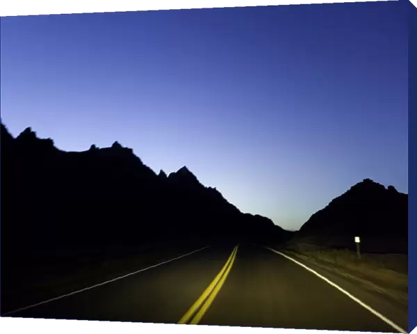 Road through sandstone buttes, night (blurred motion)