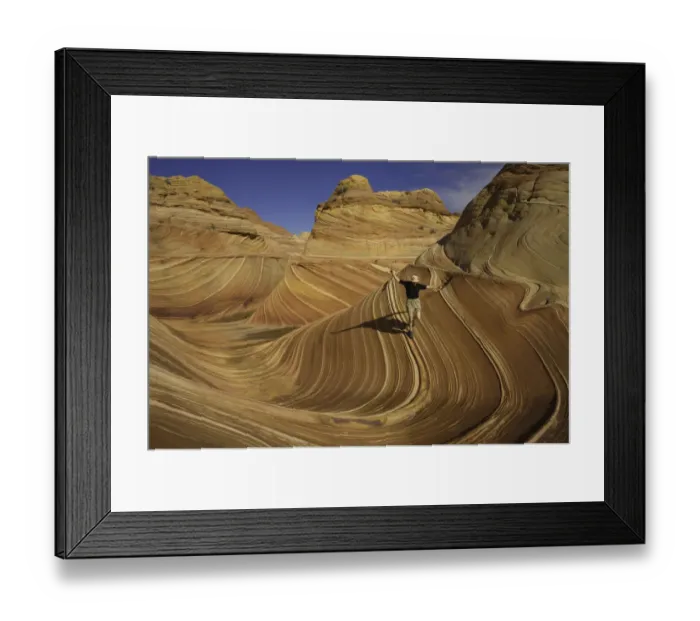 Framed Print : Mature man running down sandstone butte, arms raised Framed Print : Mature man running down sandstone butte, arms raised