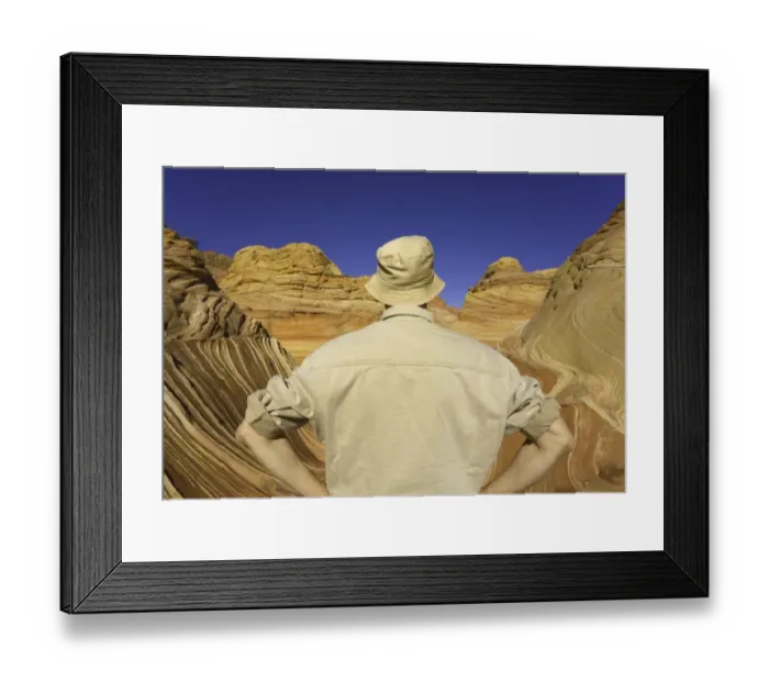 Framed Print : Mature man looking at sandstone buttes, rear view Framed Print : Mature man looking at sandstone buttes, rear view