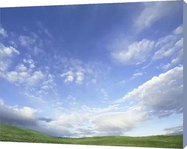 USA, Wyoming, Red Desert, cumulus clouds over grassy hillside