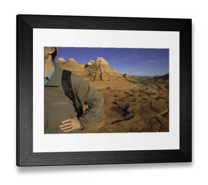 Framed Print : Man standing with hand on hip, sandstone buttes in background Framed Print : Man standing with hand on hip, sandstone buttes in background