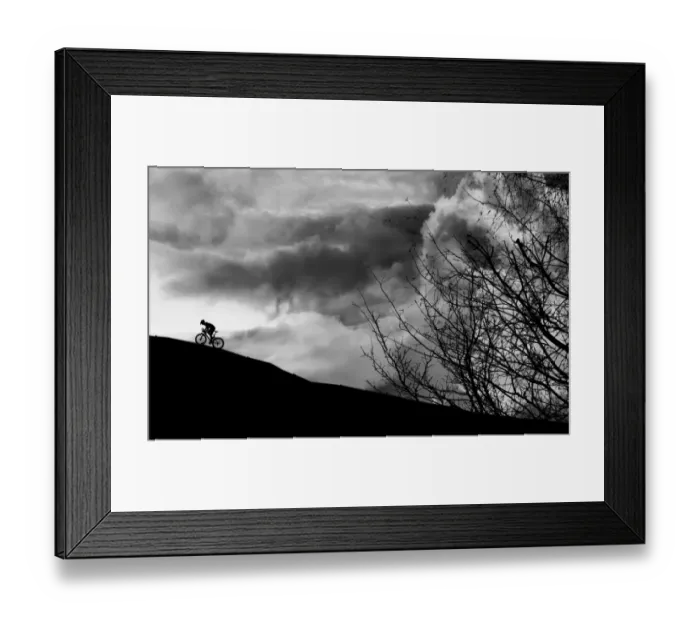 Framed Print : Dramatic cyclist climbing the mountain Framed Print : Dramatic cyclist climbing the mountain