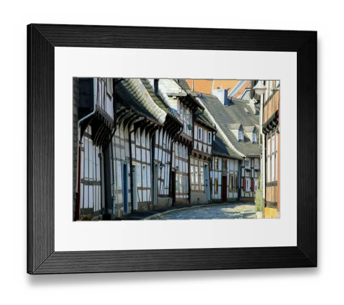 Framed Print : Half timbered houses and cobbled street in the historic old town of Goslar, Germany Framed Print : Half timbered houses and cobbled street in the historic old town of Goslar, Germany