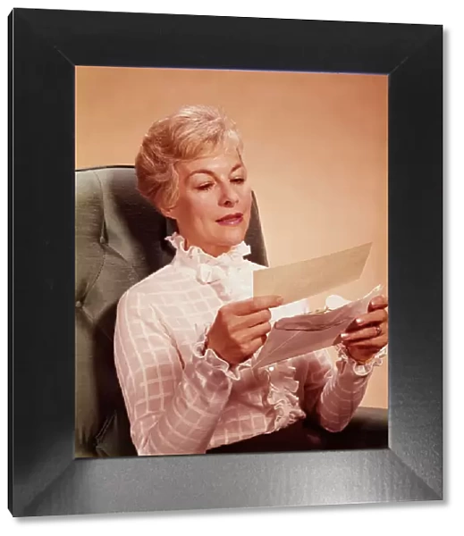Mature woman sitting in chair, reading letter. (Photo by H. Armstrong Roberts  /  Retrofile  /  Getty Images)
