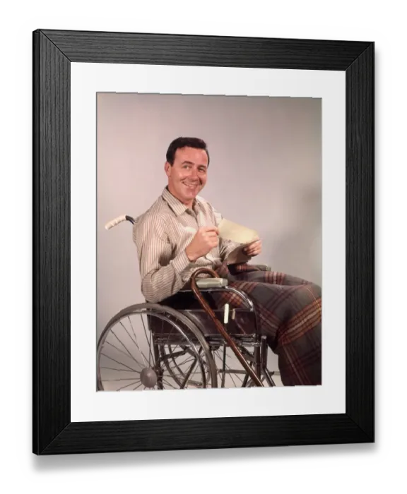 Framed Print : Smiling man in wheelchair, holding insurance check Framed Print : Smiling man in wheelchair, holding insurance check