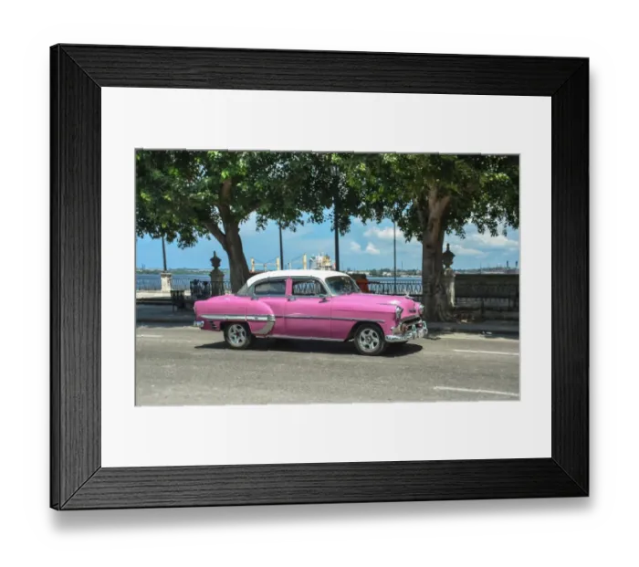 Framed Print : Real Cuban city life image with a pink vintage car riding by Havanas harbor Framed Print : Real Cuban city life image with a pink vintage car riding by Havanas harbor