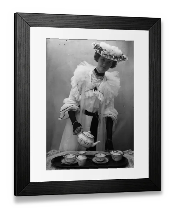 Framed Print : High Tea. A woman in Edwardian dress pouring tea. (Photo by F J Mortimer / Getty Images) Framed Print : High Tea. A woman in Edwardian dress pouring tea. (Photo by F J Mortimer / Getty Images)