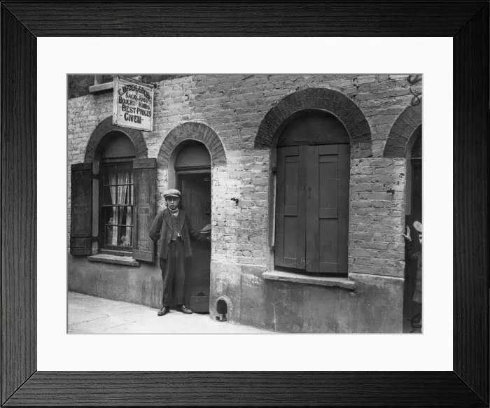 Framed Print : Bag Man. circa 1900: A youth standing outside C Middleburgs sacks