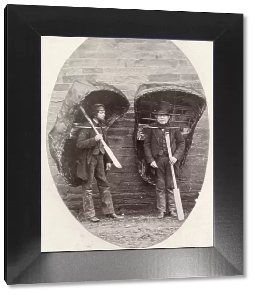 Coracles. 1856: Two men carrying their coracles - wicker boats covered
