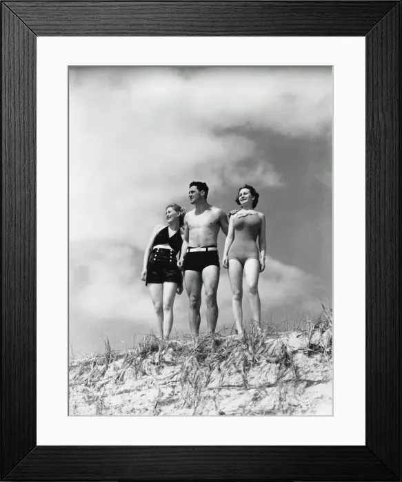Framed Print : Man and two women standing on beach sand dune Framed Print : Man and two women standing on beach sand dune